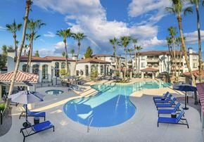 Scottsdale apartment for rent - a large swimming pool with chairs and umbrellas in front of a resort