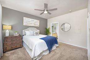 Mesa apartment for rent - a bedroom with a bed and a ceiling fan