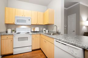 Mesa apartment for rent - an empty kitchen with white appliances and granite counter top