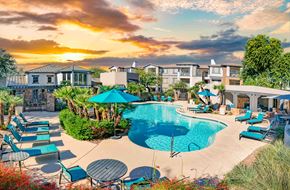 Phoenix apartment for rent - A beautiful outdoor swimming pool area with loungers and umbrellas.