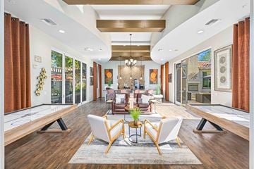 Gilbert apartment for rent - A well-lit, modern living room with a pool table and comfortable seating.