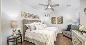 Scottsdale apartment for rent - a bedroom with a large bed and a ceiling fan