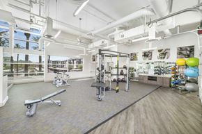 Tempe apartment for rent - A gym with a variety of equipment including a treadmill, weights, and a stationary bike.