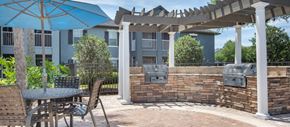 Wesley Chapel apartment for rent - a patio with a table and chairs and an umbrella