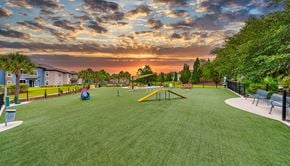 Tampa apartment for rent - a park with a playground and benches on the grass