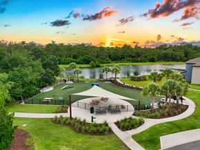 Tampa apartment for rent - a park with a basketball court and a lake at sunset
