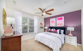Windermere apartment for rent - A bedroom with a bed, nightstand, and a ceiling fan.
