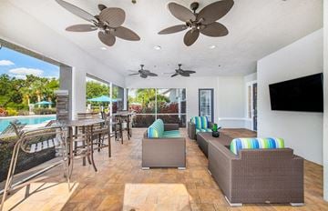 Lakewood Ranch apartment for rent - a living room with couches and chairs and a pool