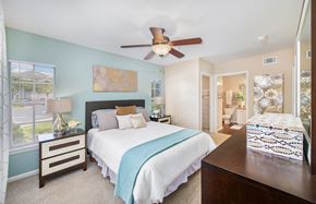 Lakewood Ranch apartment for rent - a bedroom with a large bed and a ceiling fan