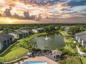 Brandon apartment for rent - a fountain in the middle of a pond with houses around it