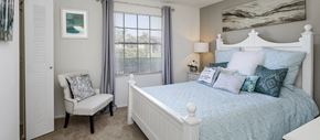 Brandon apartment for rent - a bedroom with a bed and a chair and a window