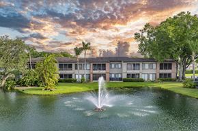 Tampa apartment for rent - a fountain in a pond with a building in the background