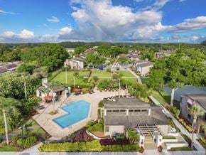 Tampa apartment for rent - an aerial view of a neighborhood with a swimming pool and a park