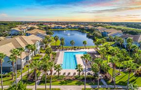Orlando apartment for rent - an aerial view of a swimming pool surrounded by palm trees