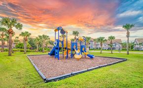 Orlando apartment for rent - a playground at the park at sunset with palm trees