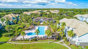 Orlando apartment for rent - a mansion with a swimming pool and palm trees