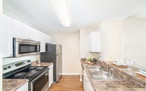 Orlando apartment for rent - a kitchen with stainless steel appliances and granite counter tops