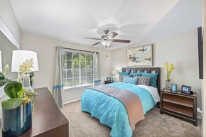 Heathrow apartment for rent - a bedroom with a bed and a ceiling fan