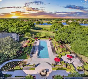 Heathrow apartment for rent - an aerial view of a pool and a backyard with trees