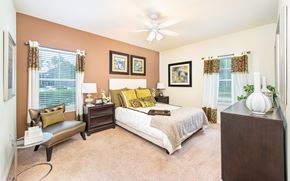Lake Mary apartment for rent - a bedroom with a bed and a ceiling fan