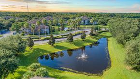 Orlando apartment for rent - an aerial view of a community with a pond and trees