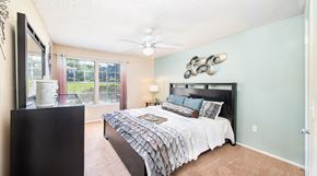 Altamonte Springs apartment for rent - a bedroom with a bed and a ceiling fan
