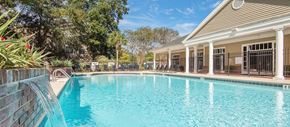 Charleston apartment for rent - a swimming pool with a house in the background