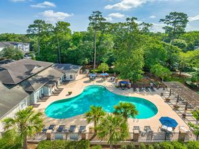 Ladson apartment for rent - an aerial view of a resort style swimming pool with palm trees