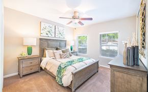 Ladson apartment for rent - a bedroom with a bed and a ceiling fan