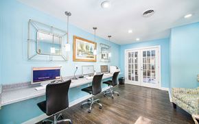 Charleston apartment for rent - a conference room with a long desk with chairs and a computer