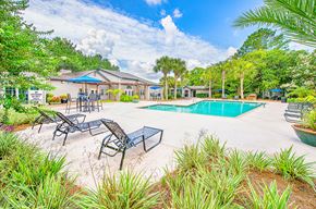 Charleston apartment for rent - our resort style swimming pool is surrounded by patio furniture and plants