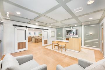 Mt Pleasant apartment for rent - A spacious living room with grey couches and a wooden floor.