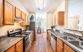 Summerville apartment for rent - a kitchen with granite counter tops and wooden cabinets