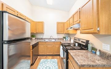 Jacksonville apartment for rent - a kitchen with stainless steel appliances and wooden cabinets