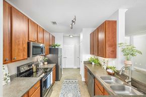 Jacksonville apartment for rent - a kitchen with stainless steel appliances and wooden cabinets