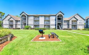 Jacksonville apartment for rent - the preserve at ballantyne commons apartments clubhouse with grass and a picnic table