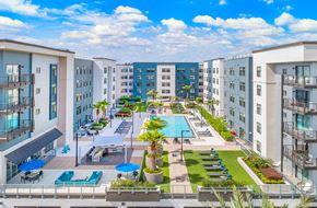 Jacksonville apartment for rent - an aerial view of an apartment complex with a pool and lawn