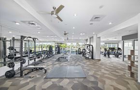 Jacksonville apartment for rent - a gym with weights and cardio machines and a ceiling fan