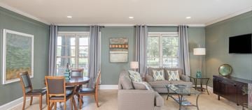 Tallahassee apartment for rent - a living room with a couch and a table and chairs