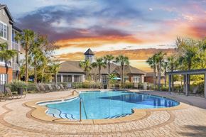 Savannah apartment for rent - A swimming pool surrounded by a brick patio and lounge chairs.