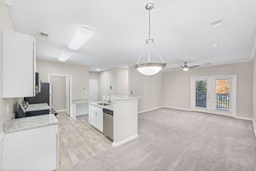Savannah apartment for rent - A spacious kitchen with white cabinets and a grey countertop.