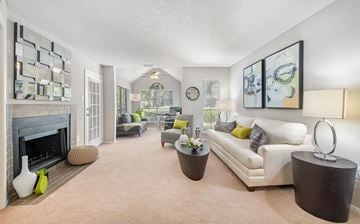 Savannah apartment for rent - a living room with a white couch and a fireplace