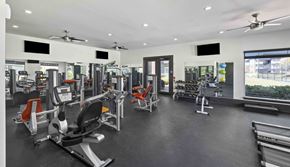 Pooler apartment for rent - A gym with a variety of equipment including treadmills, stationary bikes, and weight machines.