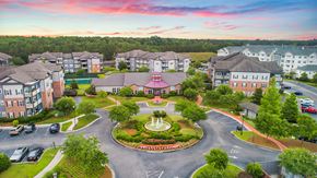 Pooler apartment for rent - an aerial view of a community with buildings and a fountain