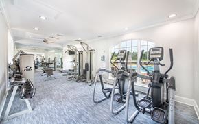 Charlotte apartment for rent - a gym with cardio machines and a large window