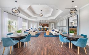 Charlotte apartment for rent - the preserve at ballantyne commons apartments clubhouse with tables and chairs