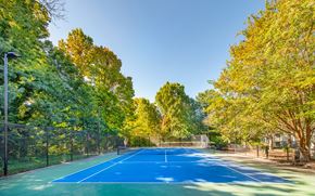 Charlotte apartment for rent - a tennis court with trees and a fence around it