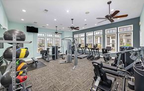 Huntersville apartment for rent - A gym with a variety of equipment including treadmills, weights, and exercise machines.