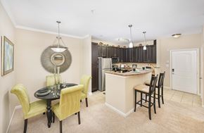 Huntersville apartment for rent - A kitchen with a table and chairs in the foreground and a counter with cabinets in the background.