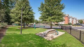 Charlotte apartment for rent - a park with a playground and trees next to a street